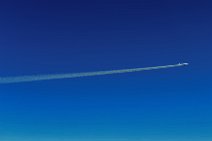 Airliner jet with vapor trail in blue skies Airliner jet with vapor trail in blue skies.jpg